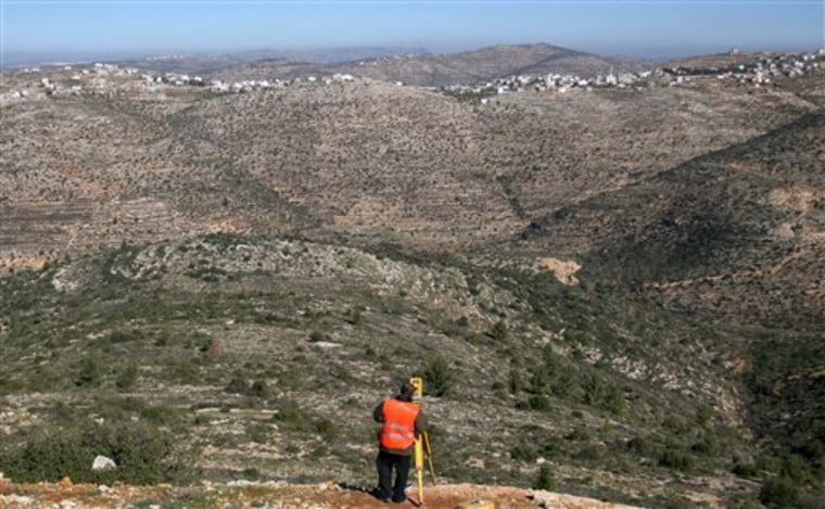 A Palestinian surveyor works at the site where the first Palestinian planned city, Rawabi, will be build near the West Bank city of Ramallah. 